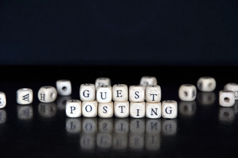 diced letters on a black surface that read guest posting