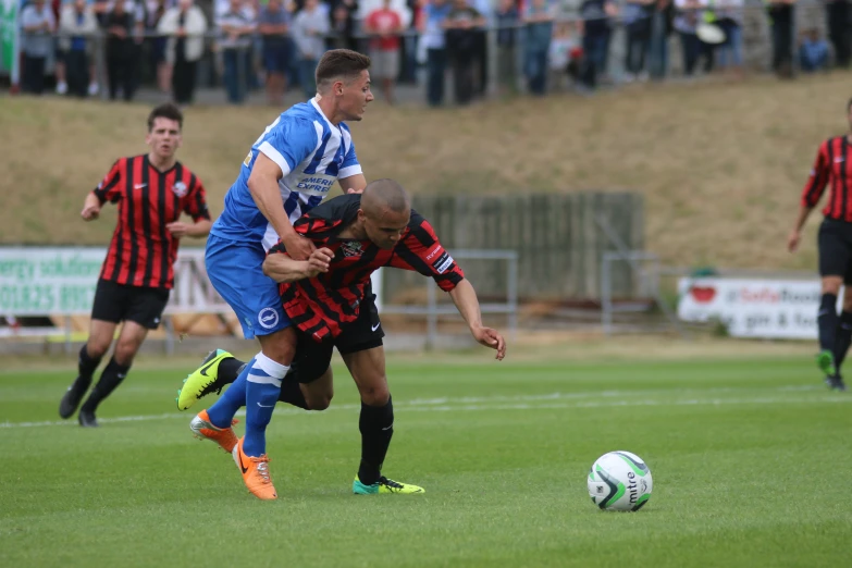 a soccer game with two players fighting for control of the ball