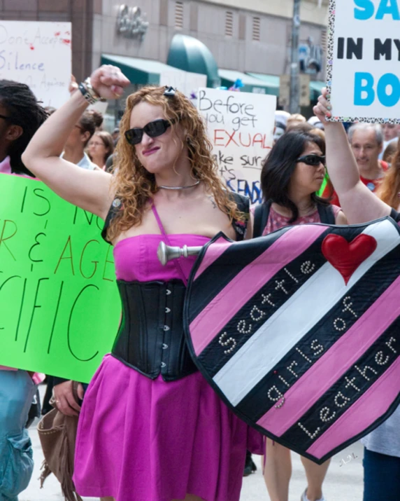 two women holding signs in their hands during a demonstration