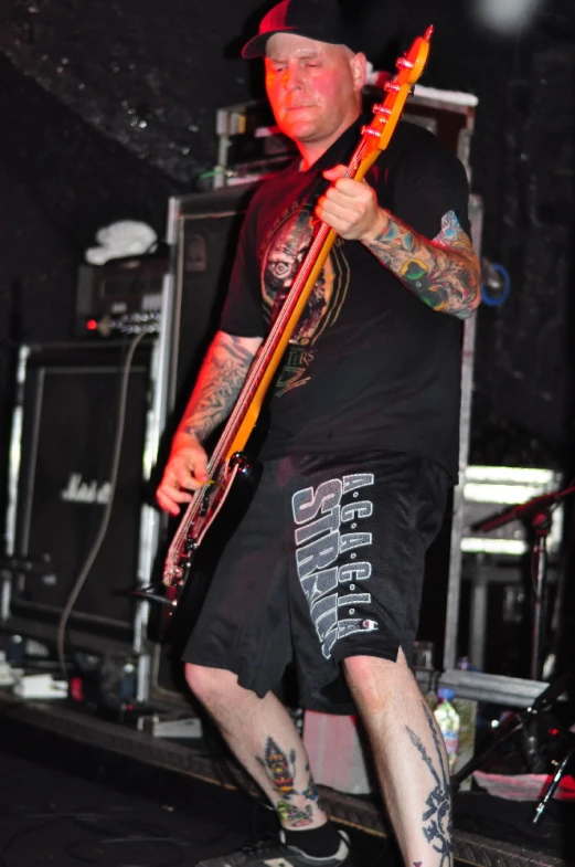 a man playing an electric guitar on stage