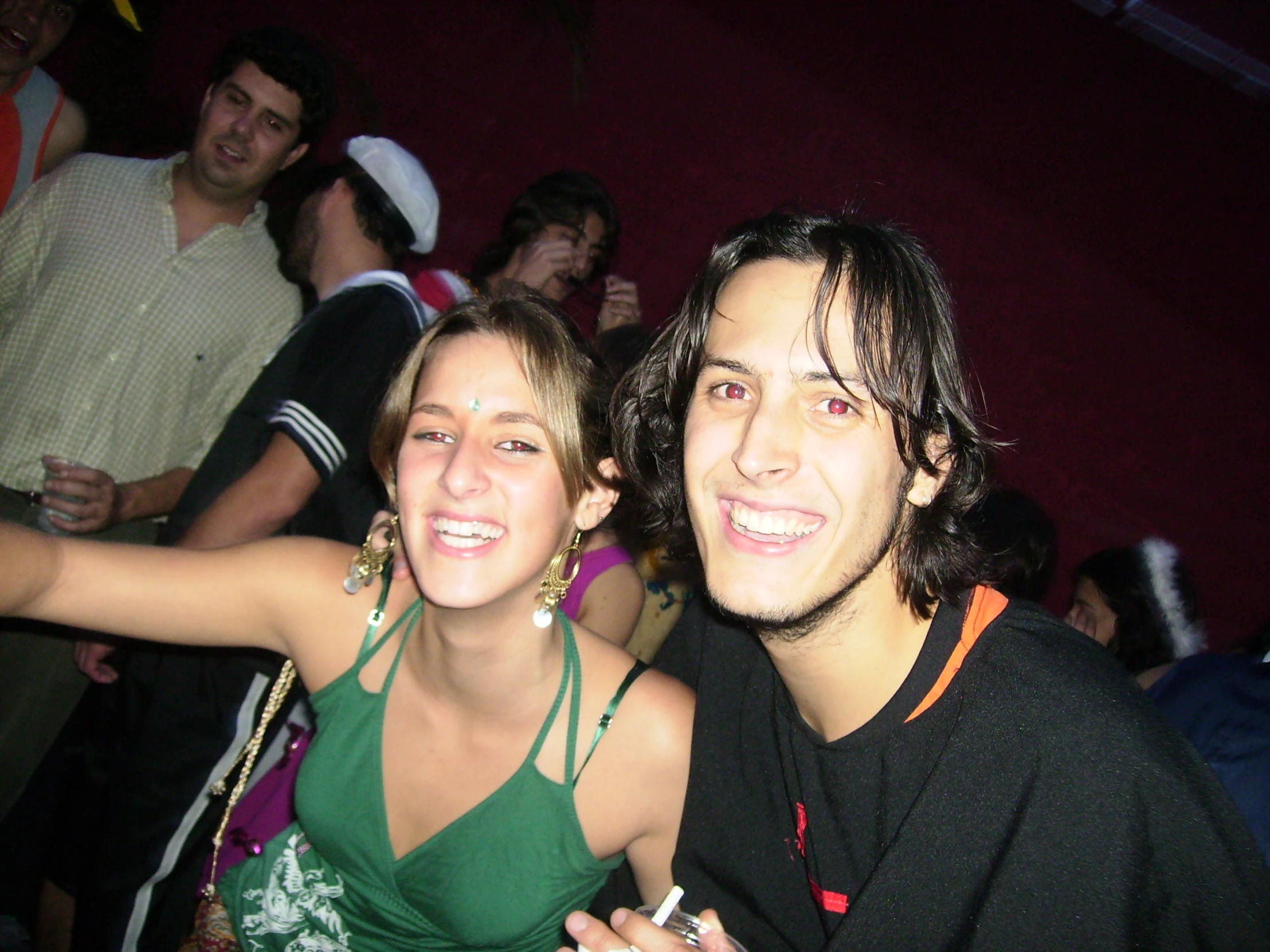 a young woman smiling next to a man