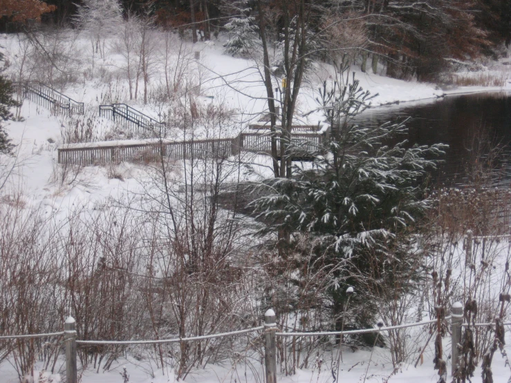 a snowy field and a bridge on the other side of it