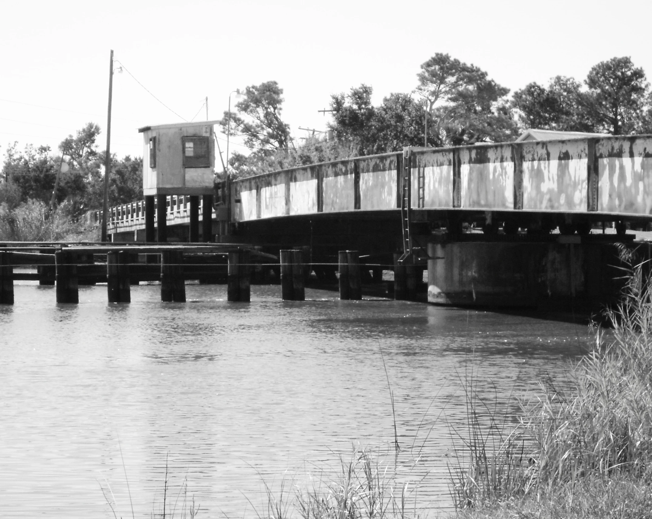 the train is crossing the overpass bridge over the water