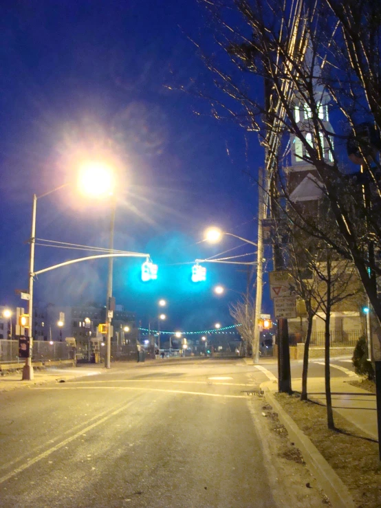 a city street at night with street signs