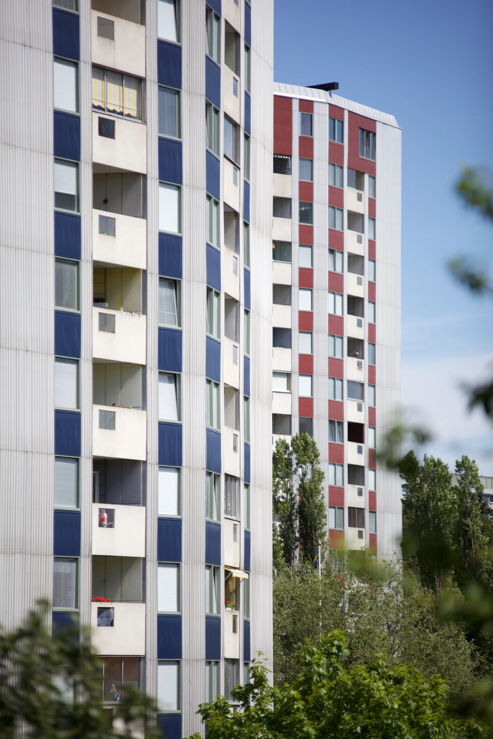 a tall building with many windows next to trees