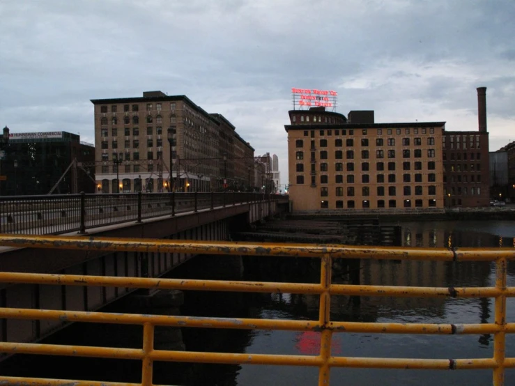 a river with a bridge over it and a tall building