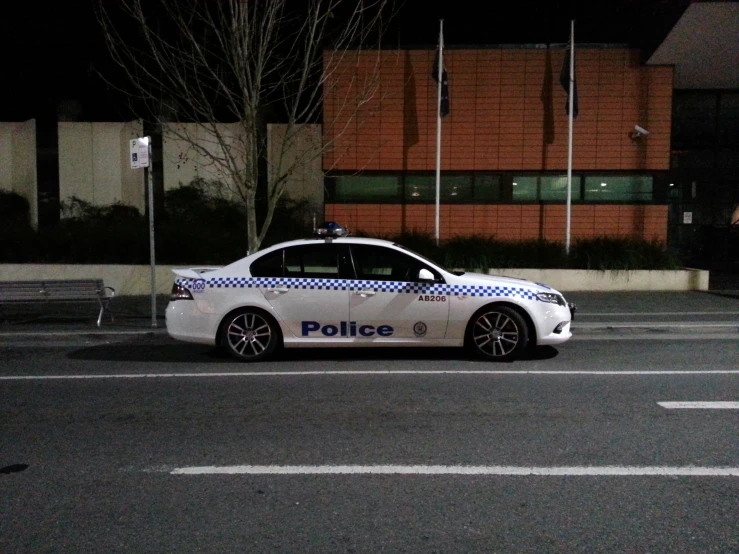 a police car that is sitting in the middle of a parking lot