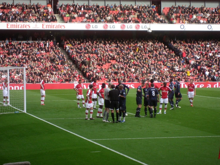 people on the field stand around talking at the game