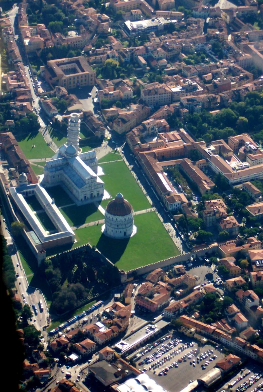 an aerial po shows a small green city in the foreground
