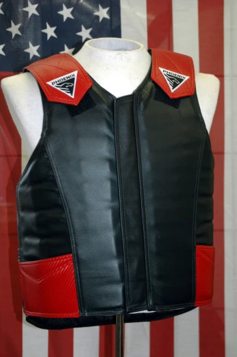 a motorcycle leather vest on display in front of an american flag