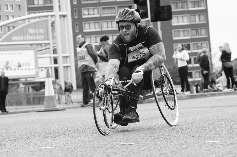 a man riding on the back of a bike across a street