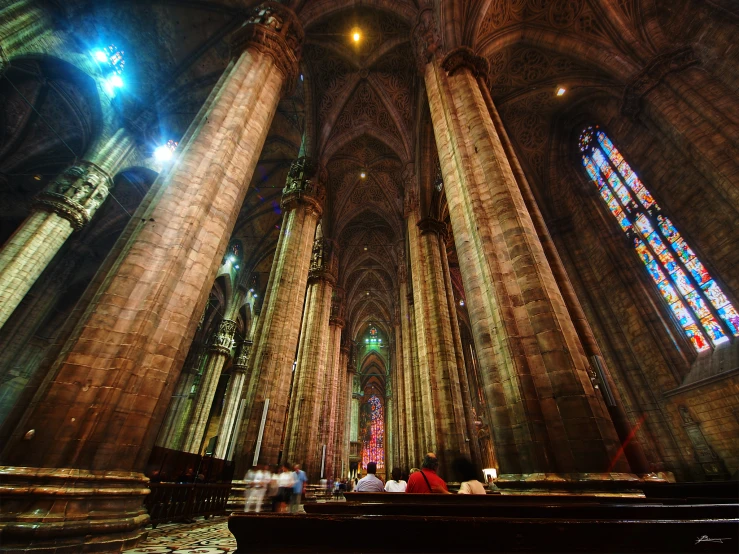 a church with multiple tall columns and stained glass windows