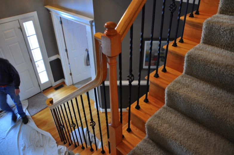 a man walks down the stairs at his home