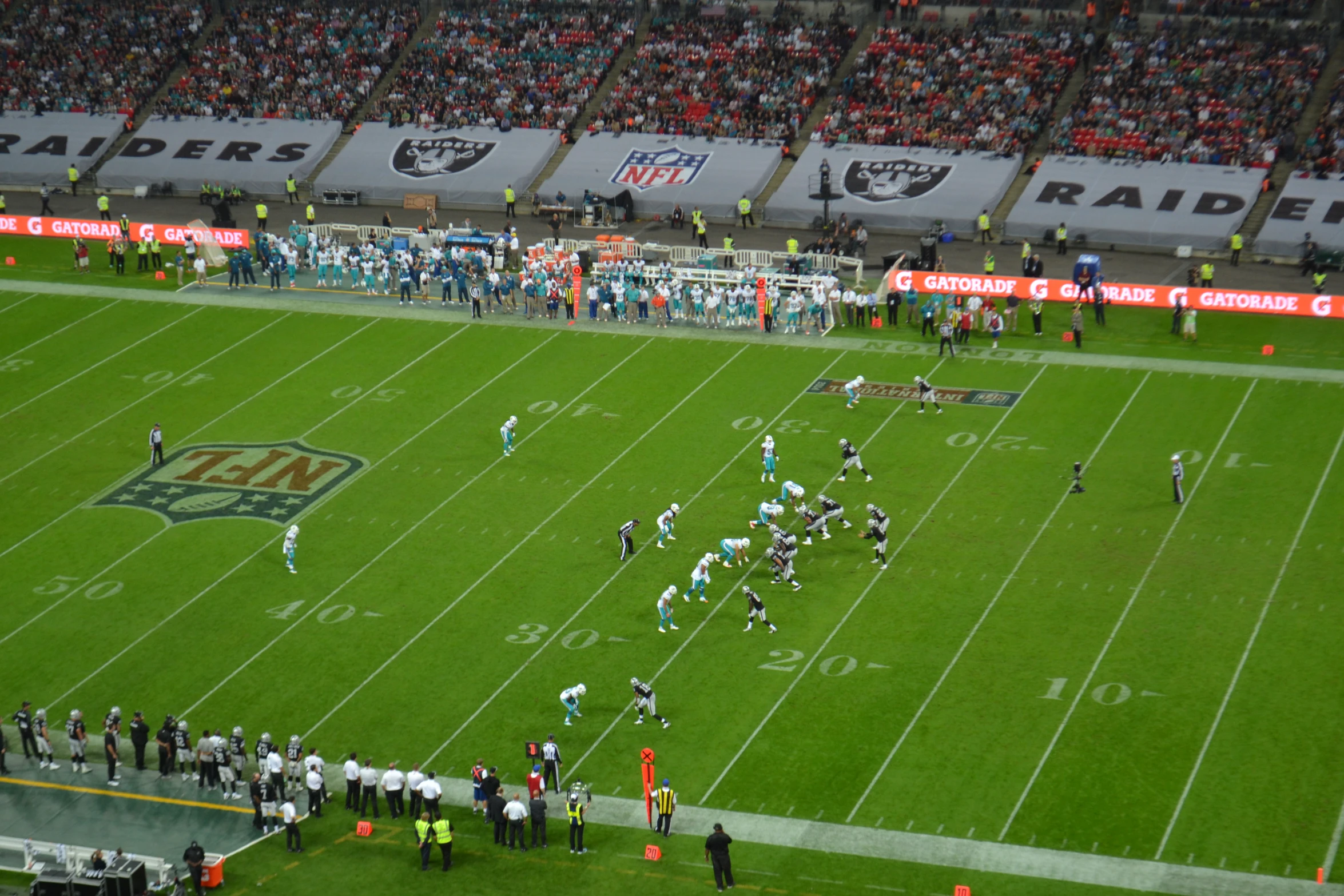 a large crowd is watching an american football game