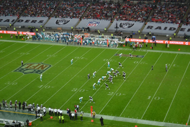 a large crowd is watching an american football game