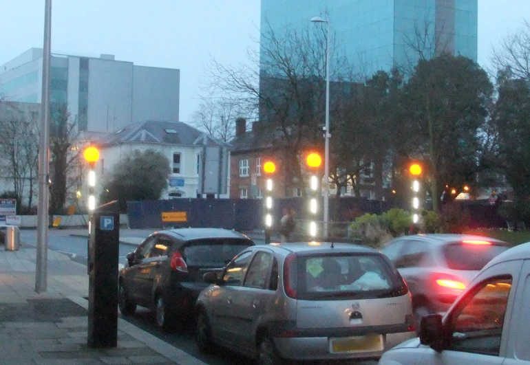 a bunch of traffic traveling down a street at dusk