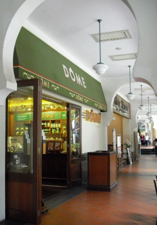 the inside of a restaurant with wooden floors and a green awning