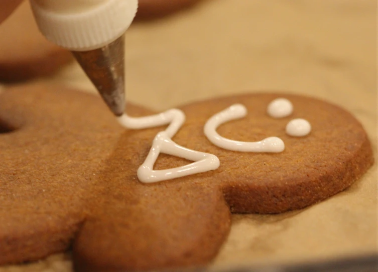 a cookie with the letters a and a face drawn on it