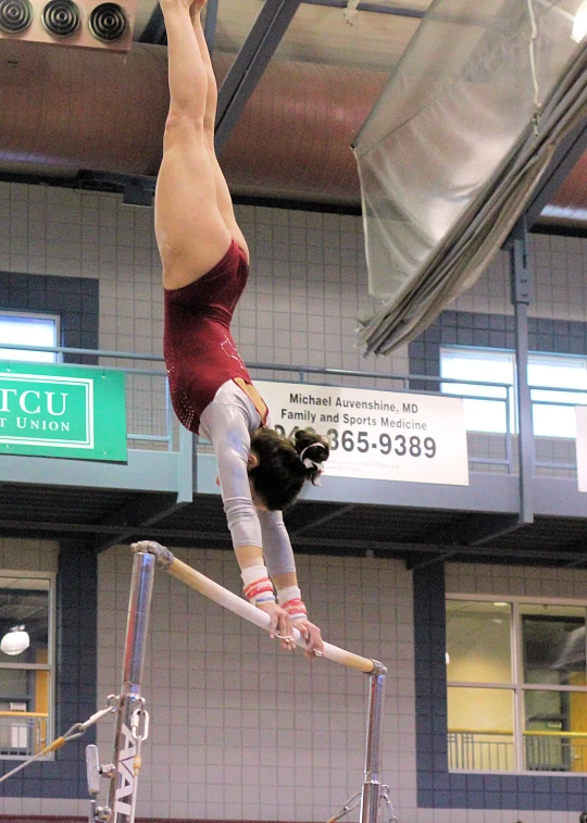 a female pole jumper is performing on the trampoline