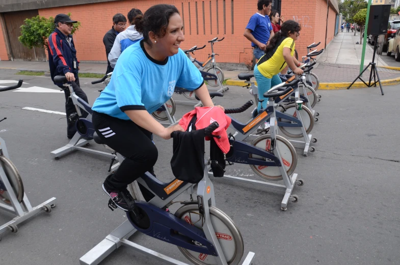 several people are riding bikes on the street