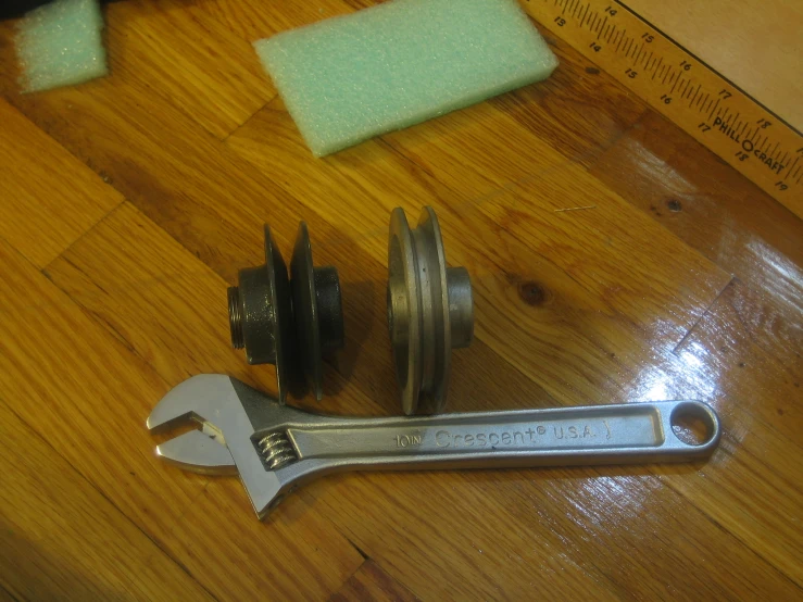 a wrench is next to a spline measuring tape