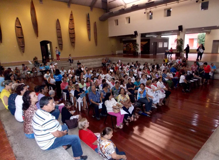 a large crowd is in the hall of a school