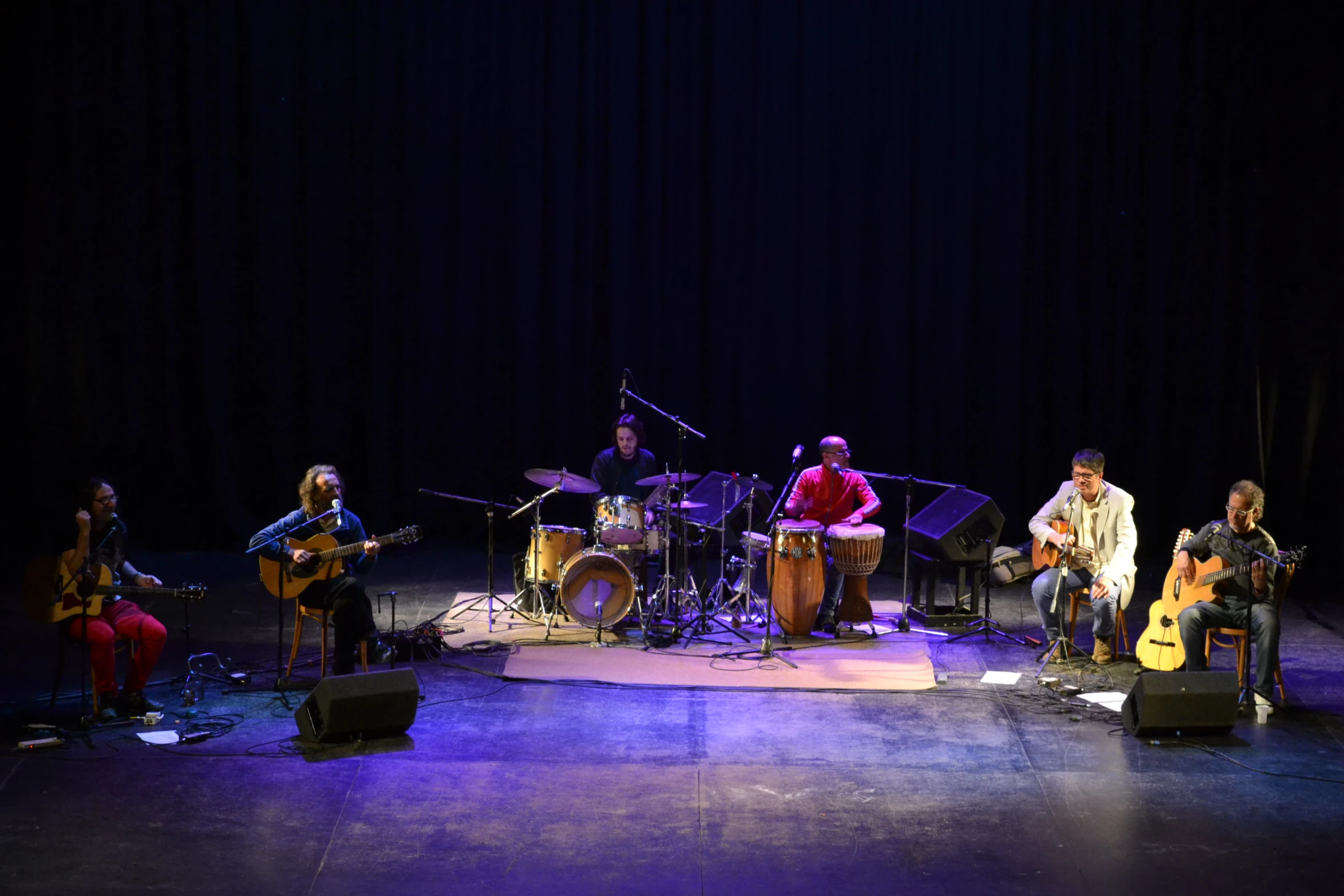 an outdoor concert with a band performing on stage