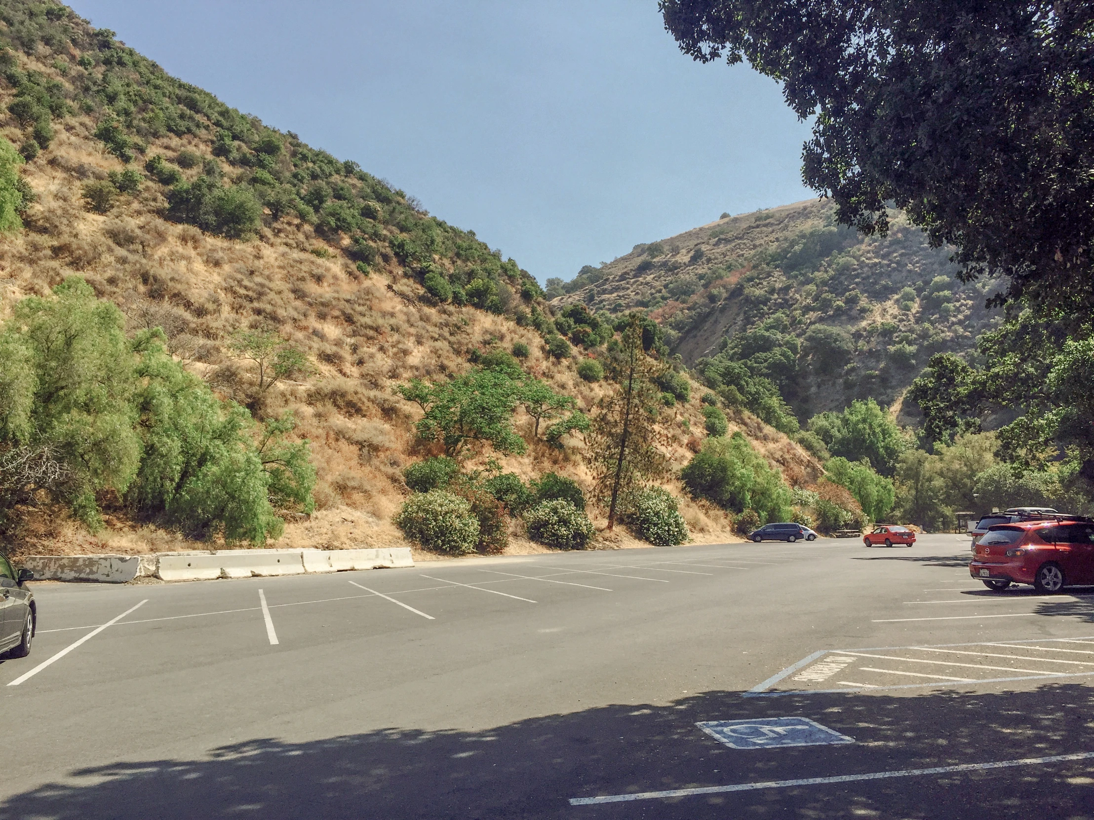 a car is parked next to a hillside