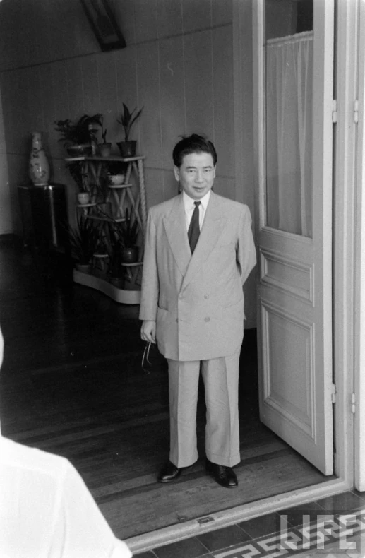 a man in a suit is standing in the door