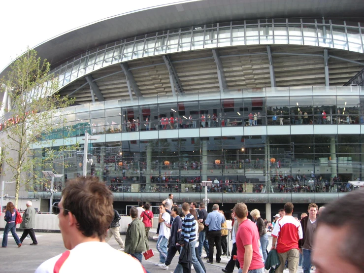 a group of people are walking near a building