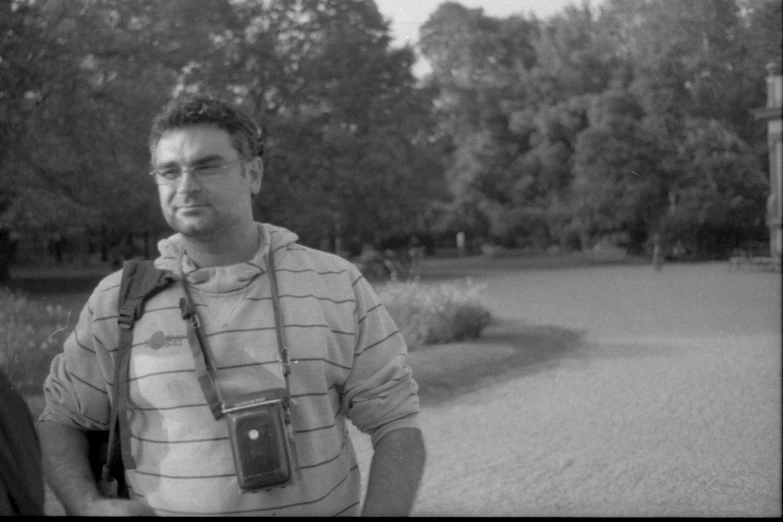a man with his camera strapped around his neck