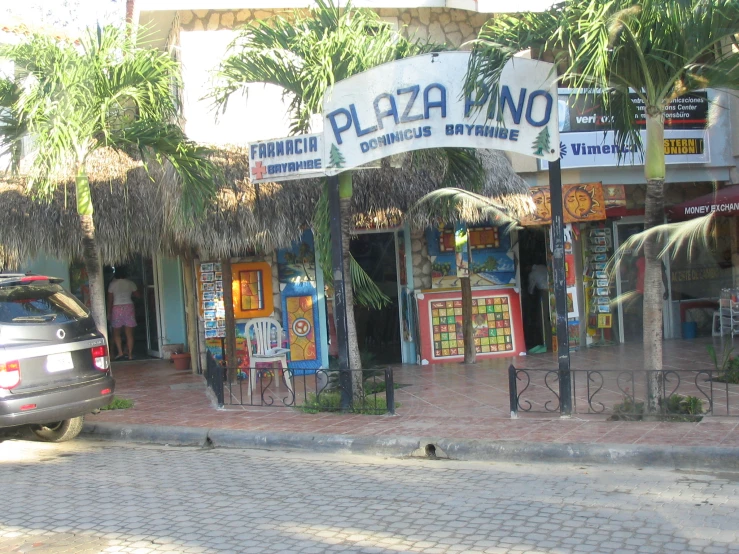 a car driving past a street with a restaurant called plaza mango