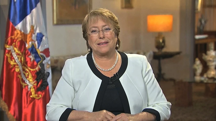 a woman standing next to an official and flags