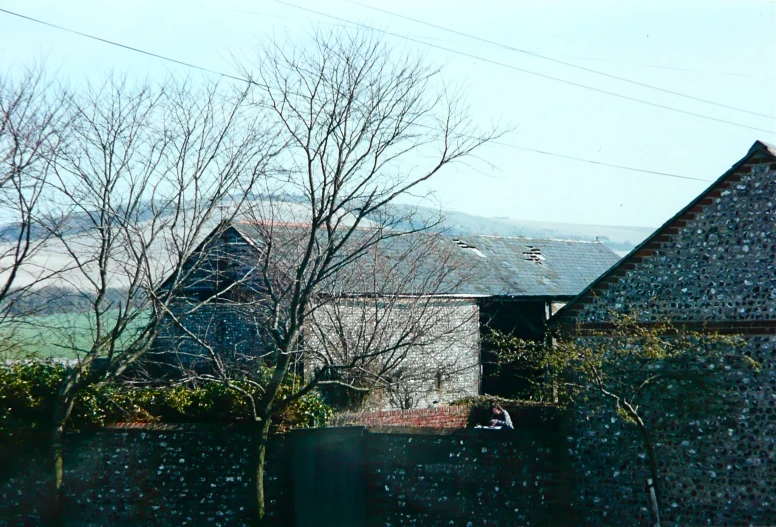 the view of the house is out through the fence