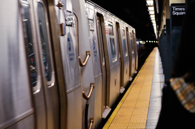 a subway platform with a metal train