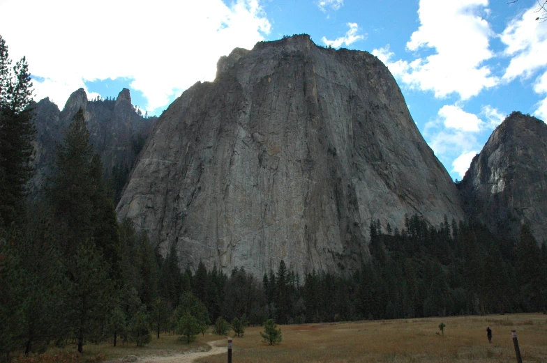 there is a very tall rock formation in the background