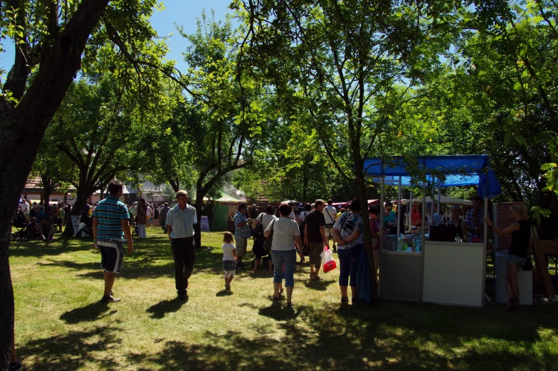 a group of people standing around in a park