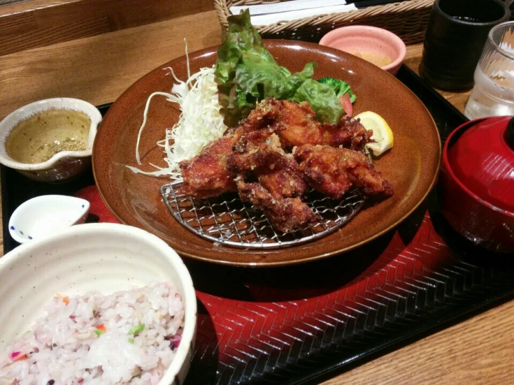 a wooden table topped with a wooden plate covered in food