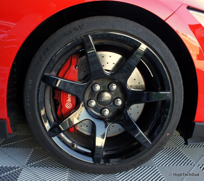 a car with two red and white stripes next to it