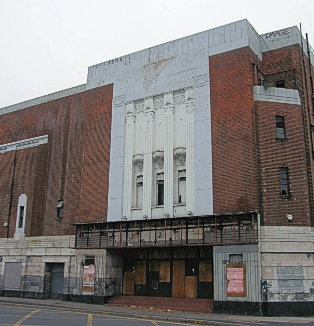 a large, old theatre in the middle of an empty street