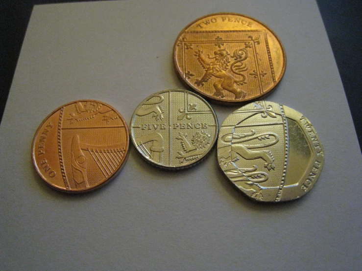 three sovereigns are in various shapes on a white surface