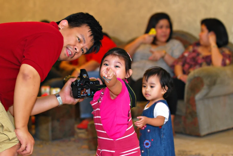 a man and two young children are taking pictures