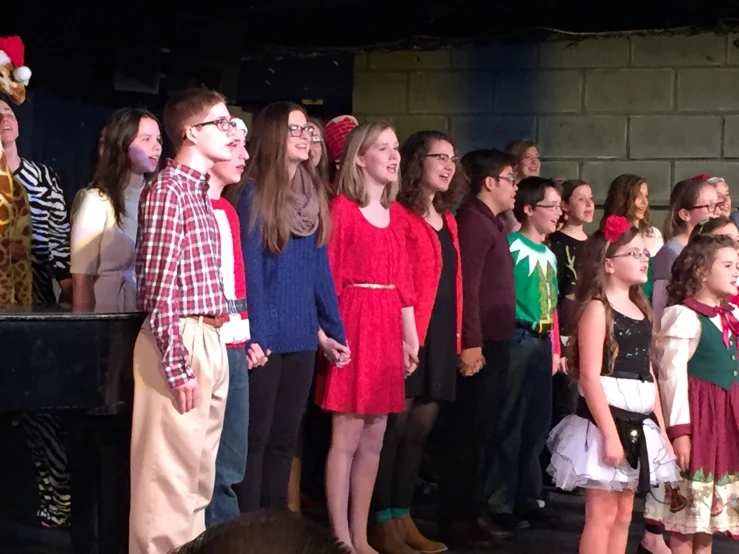 children and adults are standing in front of a group