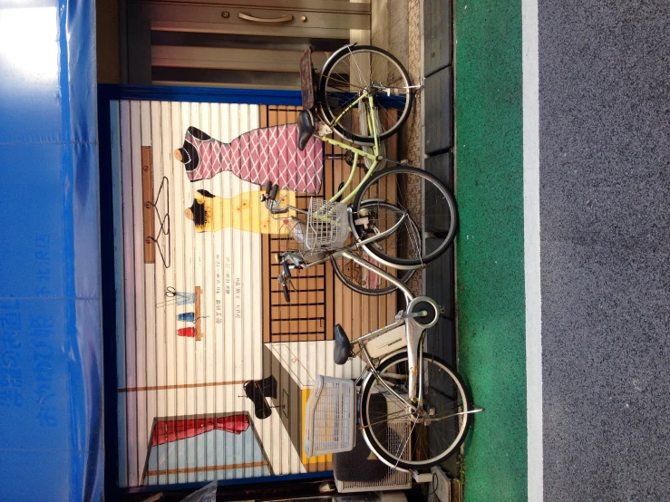 a bicycle parked in front of a store with paintings on it