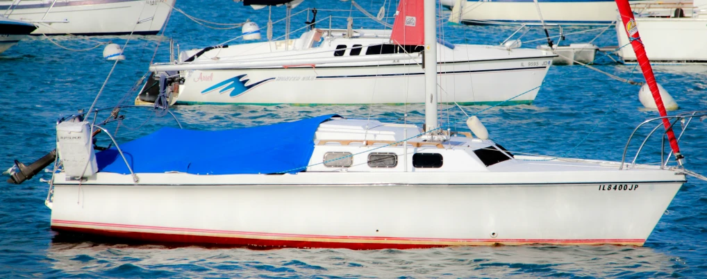 several white boats floating in a body of water