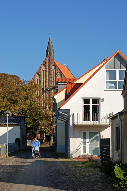 a person riding a bicycle down a small street