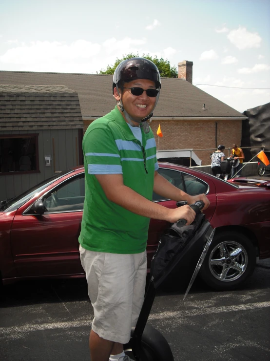 a young man wearing sunglasses rides his scooter