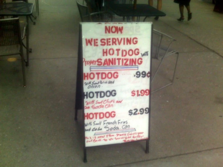 a sign for dogs and dogs is standing on the sidewalk