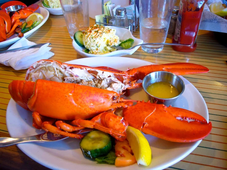 the lobster, with vegetables and sauces is sitting on the table