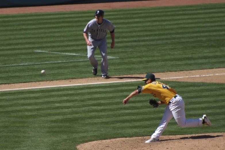 two men are playing baseball together on a field